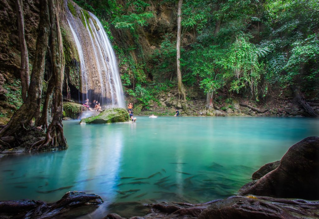 People Bathing Under Erawan Waterfall In National Park
